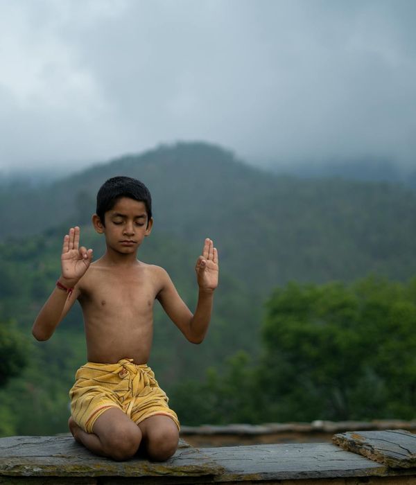 Woman practicing a calm yoga pose in a serene environment.